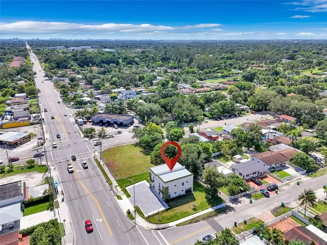 an aerial view of residential houses with outdoor space