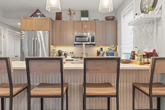 a kitchen with a sink a refrigerator and cabinets