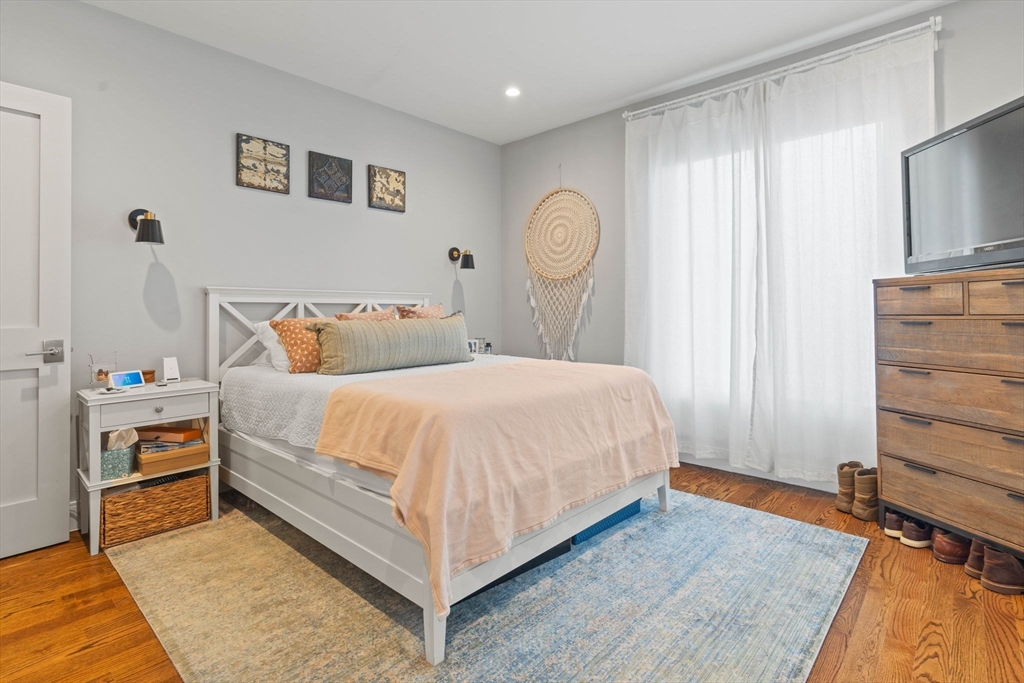 6 Ashland Street, Unit 3 Boston, MA 02122 - Photo 14 of 25 a bedroom with a bed and a flat tv screen on dresser