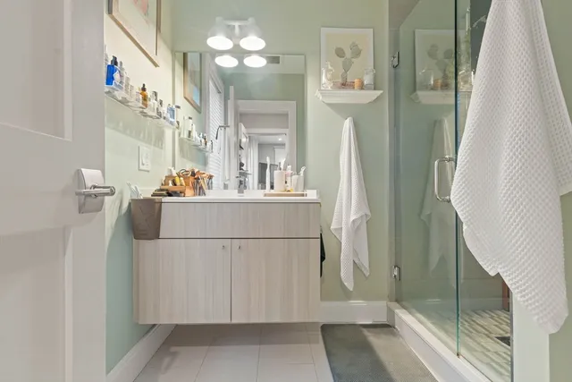 a bathroom with a sink a mirror and a shower