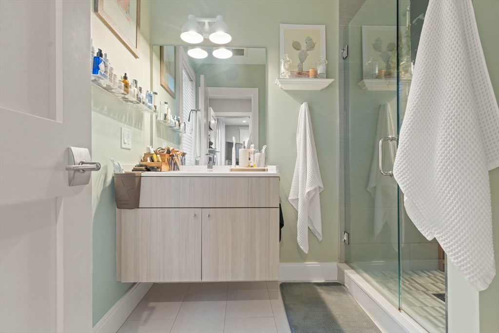 6 Ashland Street, Unit 3 Boston, MA 02122 - Photo 16 of 25 a bathroom with a sink a mirror and a shower