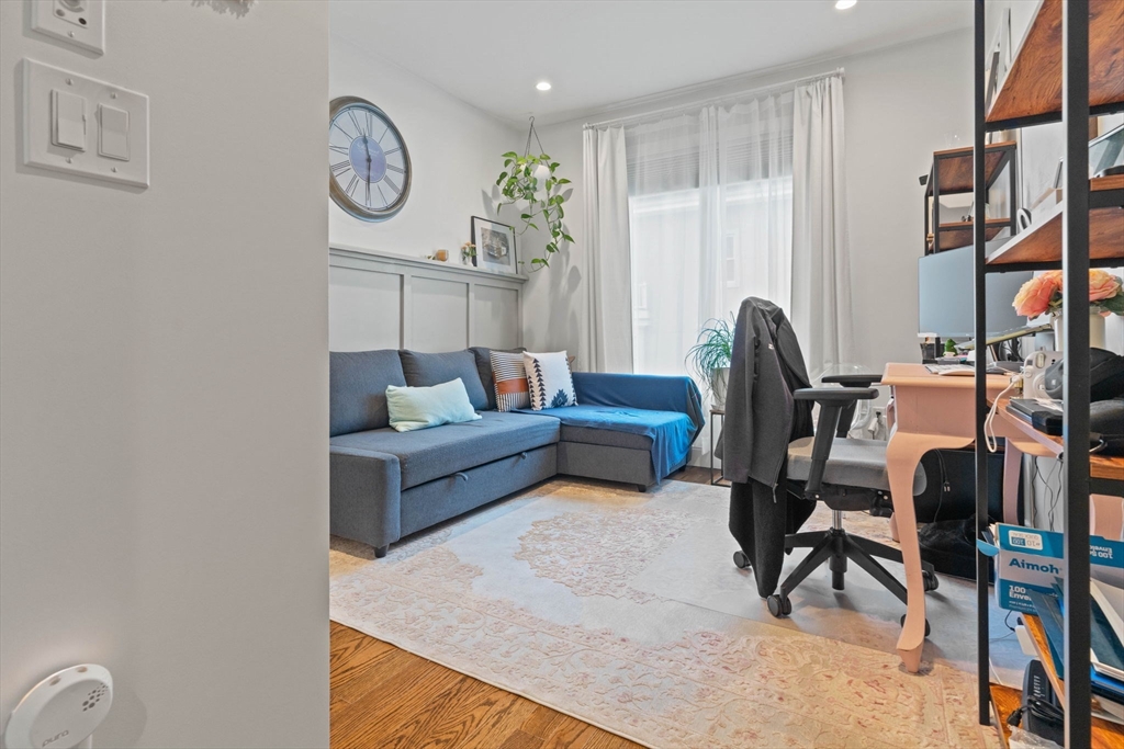 6 Ashland Street, Unit 3 Boston, MA 02122 - Photo 18 of 25 a living room with furniture and a large window
