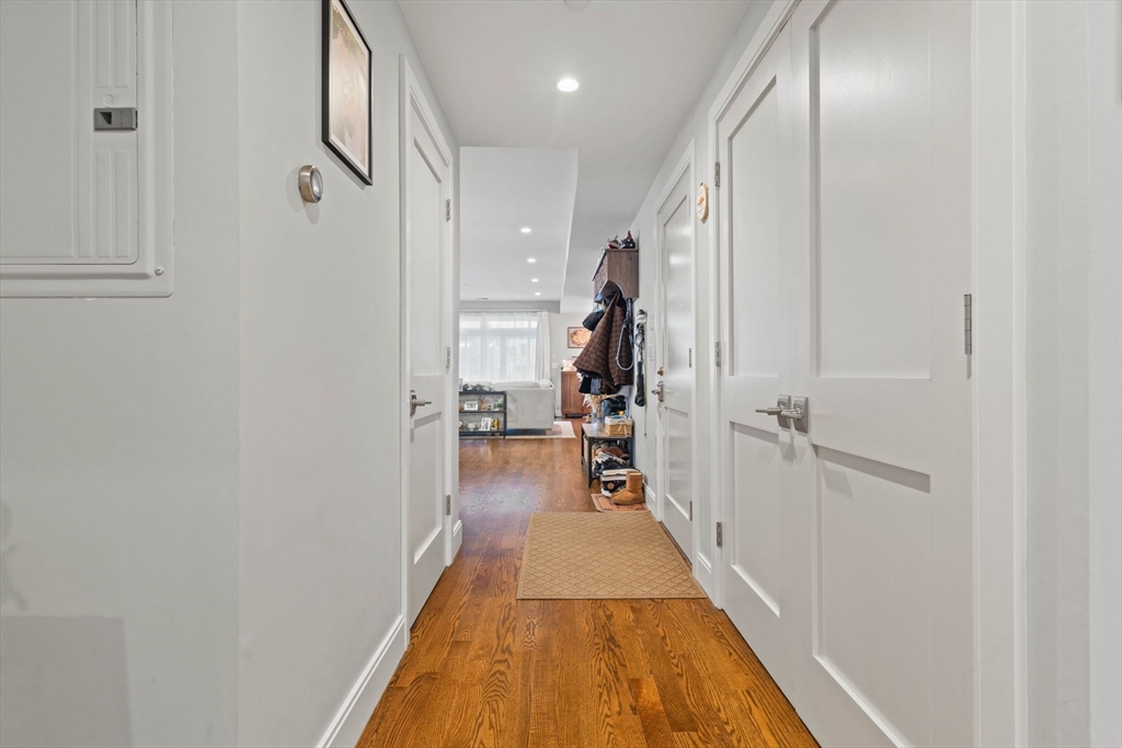 6 Ashland Street, Unit 3 Boston, MA 02122 - Photo 22 of 25 a view of a hallway with wooden floor and staircase