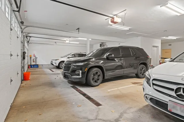 a view of parking garage with cars parked