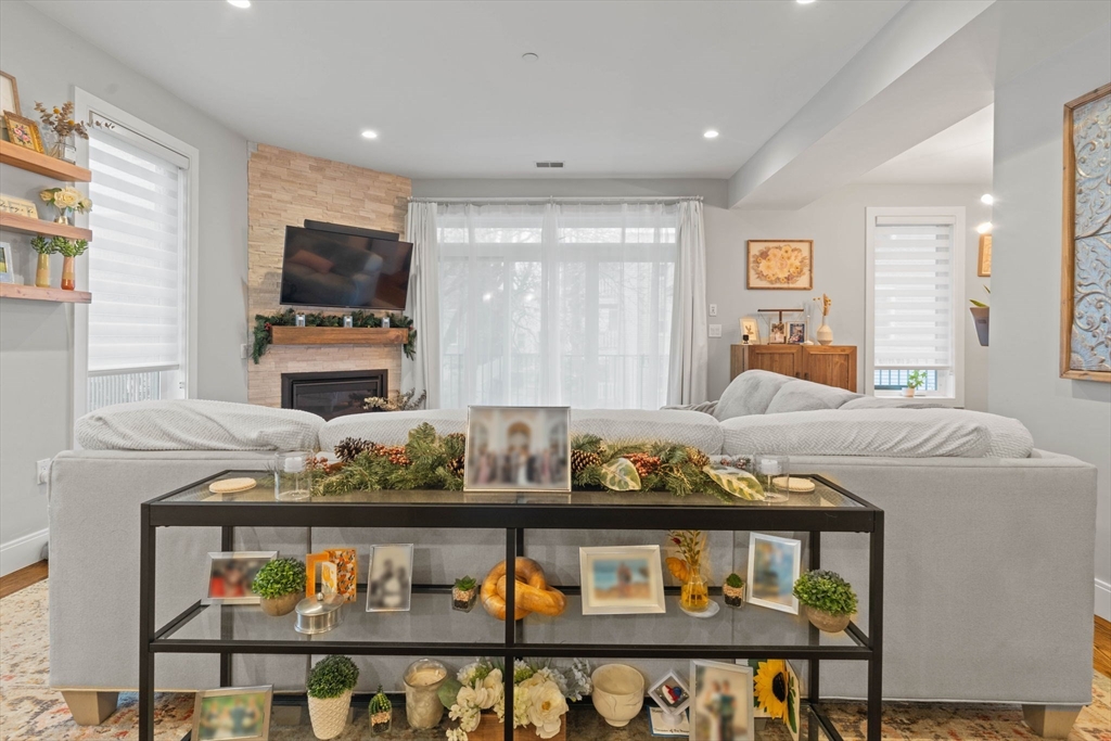 6 Ashland Street, Unit 3 Boston, MA 02122 - Photo 9 of 25 a living room with furniture kitchen view and a flat screen tv