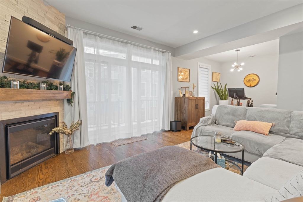 6 Ashland Street, Unit 3 Boston, MA 02122 - Photo 10 of 25 a living room with furniture and a flat screen tv