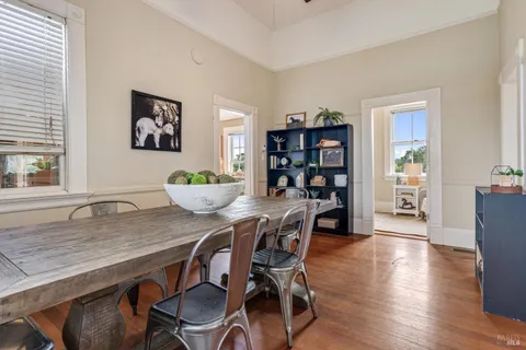a dining room with furniture and wooden floor