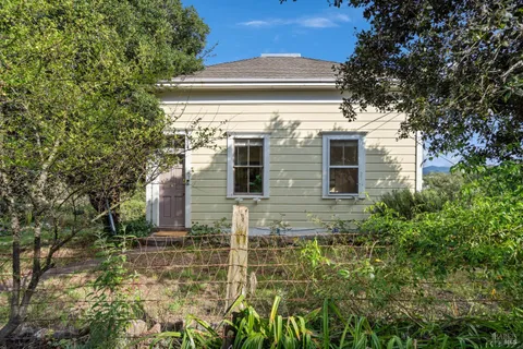 a front view of a house with plants