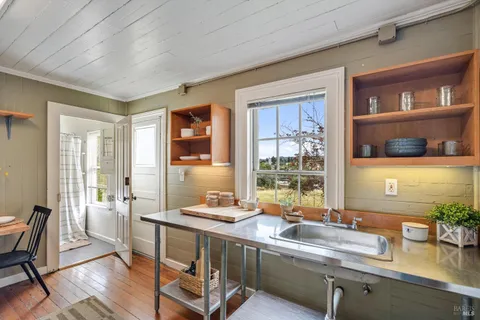 a dining room with a large window table and chairs