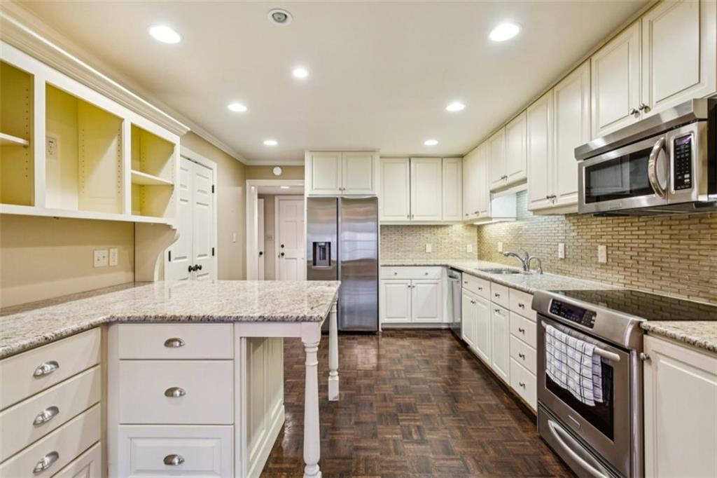 650 Moores Mill Road Northwest, Unit 19 Atlanta, GA 30327 - Photo 19 of 48 a kitchen with granite countertop cabinets stainless steel appliances and a sink