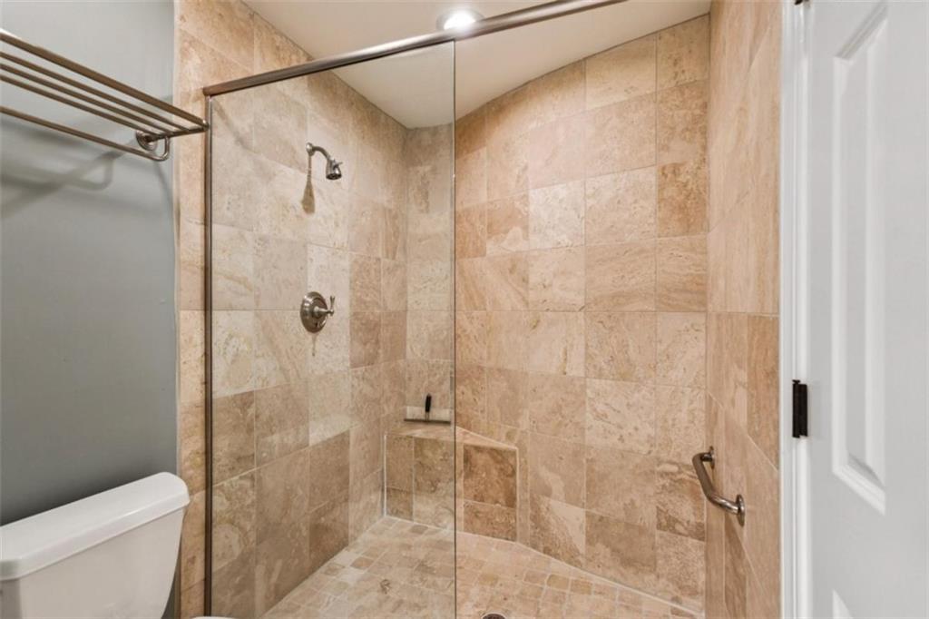 650 Moores Mill Road Northwest, Unit 19 Atlanta, GA 30327 - Photo 32 of 48 a bathroom with a shower and a toilet