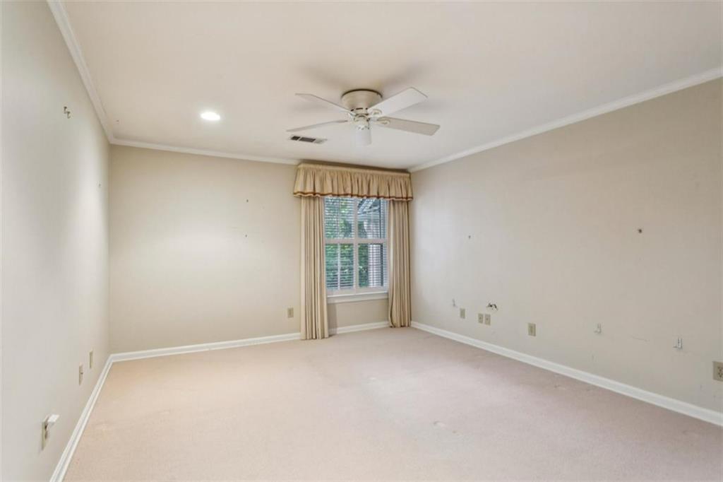 650 Moores Mill Road Northwest, Unit 19 Atlanta, GA 30327 - Photo 34 of 48 an empty room with a window and a ceiling fan