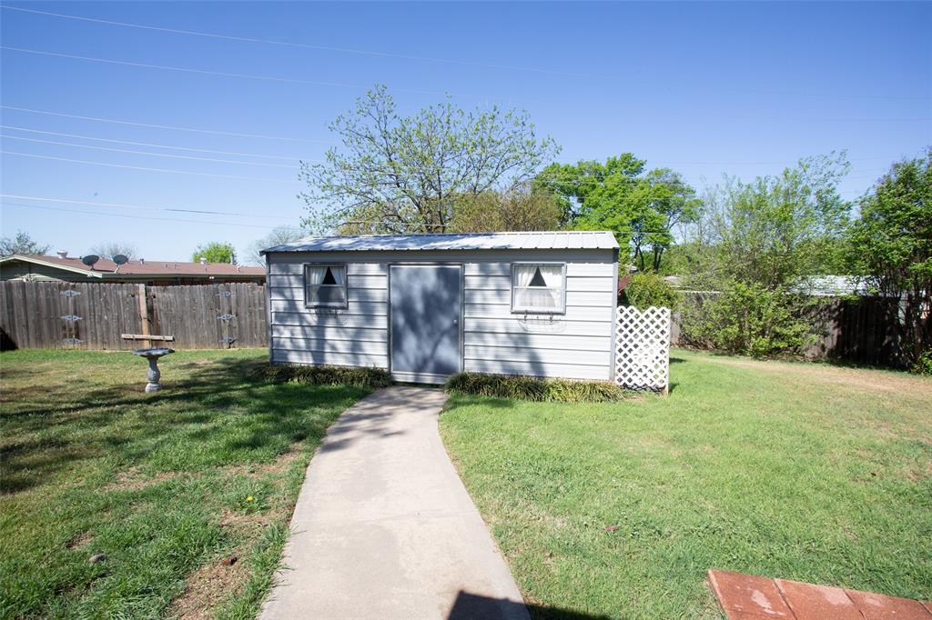 914 Fairview Street Graham, TX 76450 - Photo 16 of 17 a view of a house with a yard and sitting area