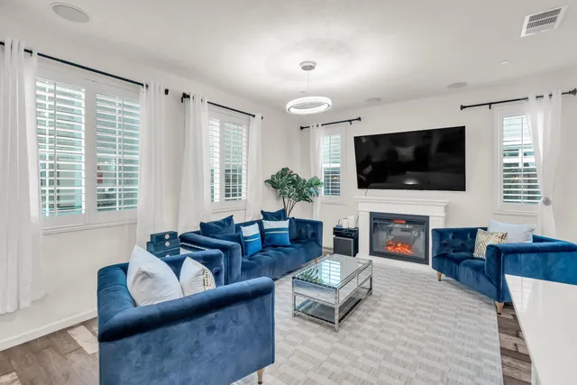 a living room with fireplace furniture and a flat screen tv