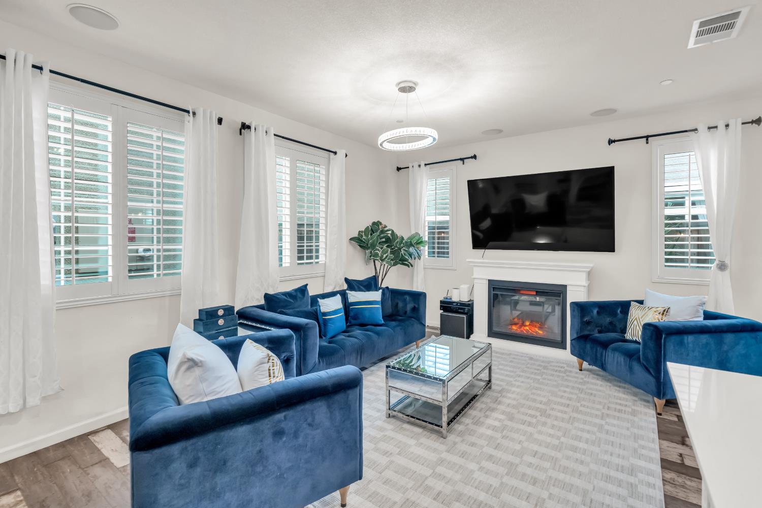 a living room with fireplace furniture and a flat screen tv