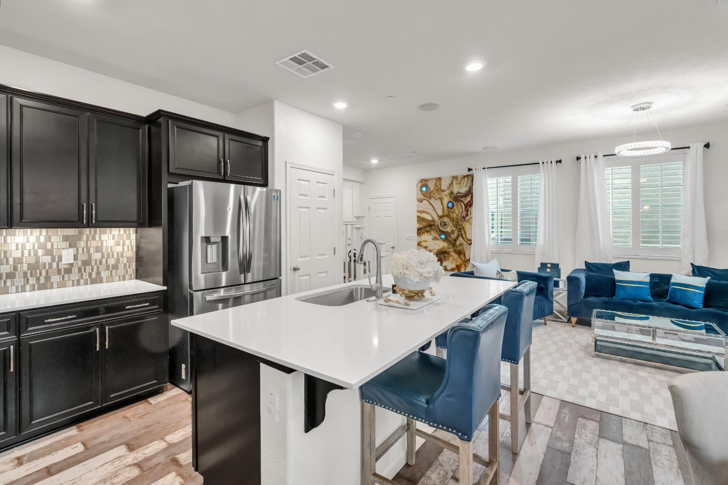 8193 Kramer Ranch Way Elk Grove, CA 95758 - Photo 11 of 48 a kitchen with stainless steel appliances kitchen island granite countertop a refrigerator a stove a sink a dining table and chairs