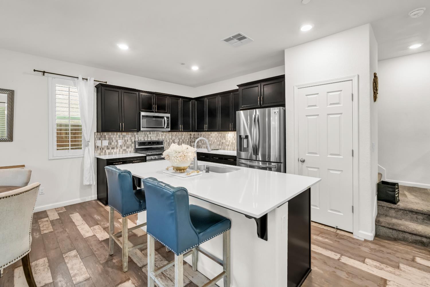 8193 Kramer Ranch Way Elk Grove, CA 95758 - Photo 13 of 48 a large kitchen with kitchen island a sink stove and refrigerator