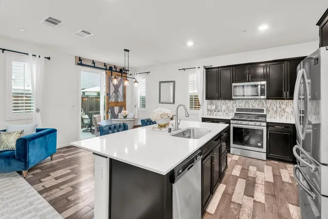 a kitchen with a sink stove and refrigerator