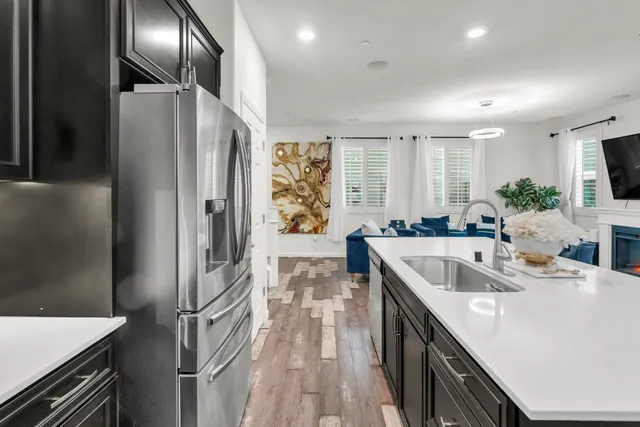 a kitchen with counter top space sink and refrigerator