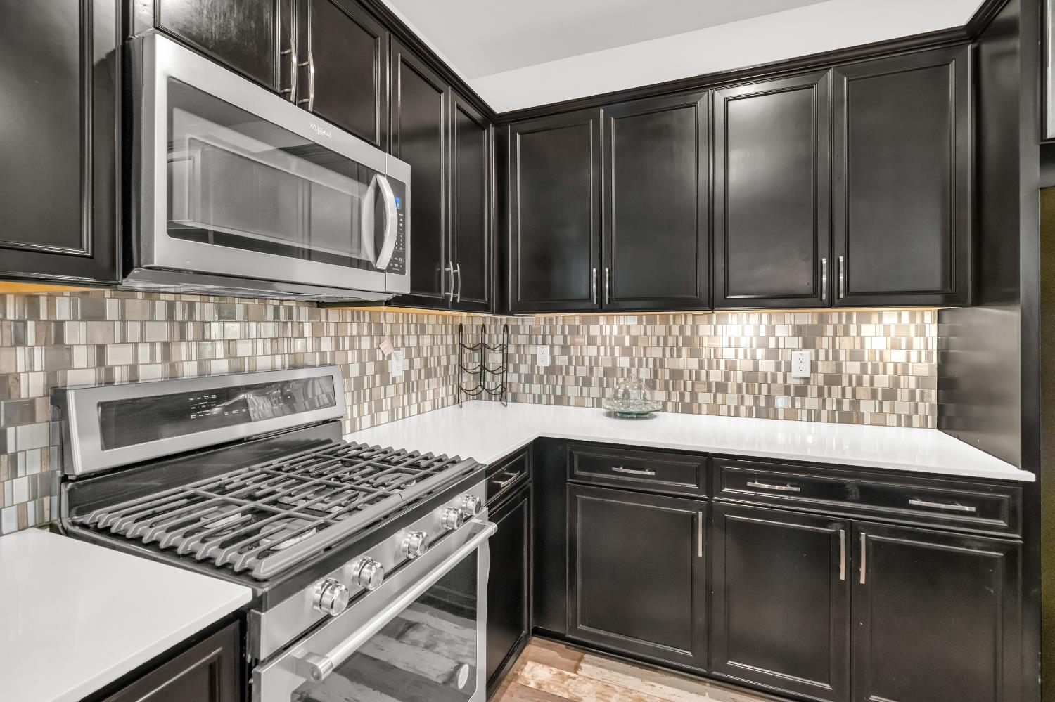 8193 Kramer Ranch Way Elk Grove, CA 95758 - Photo 17 of 48 a kitchen with granite countertop a stove sink and cabinets