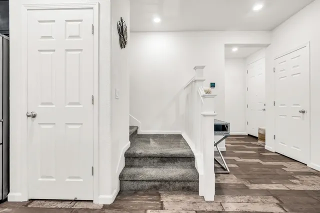 a view of an entryway with wooden floor and door