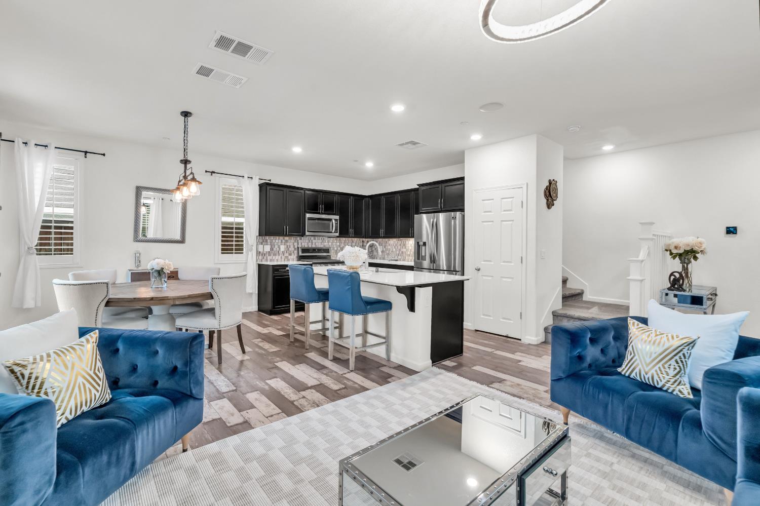 8193 Kramer Ranch Way Elk Grove, CA 95758 - Photo 2 of 48 a living room with furniture kitchen view and a chandelier