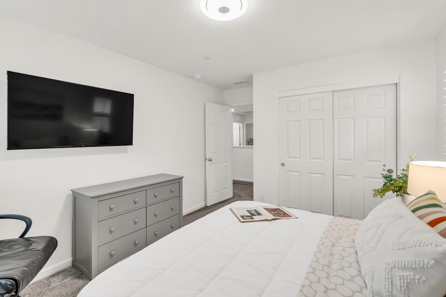 8193 Kramer Ranch Way Elk Grove, CA 95758 - Photo 23 of 48 a bedroom with a bed and a flat screen tv