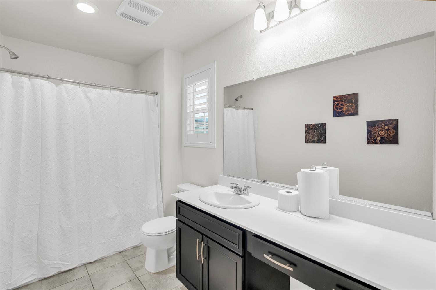 8193 Kramer Ranch Way Elk Grove, CA 95758 - Photo 24 of 48 a bathroom with a sink a toilet and shower curtain