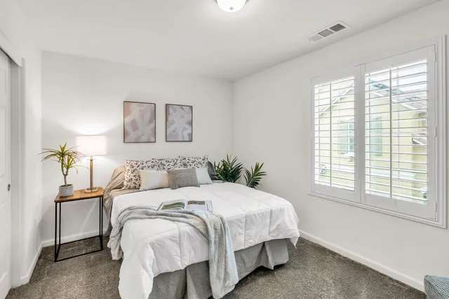 a bedroom with a bed and a window