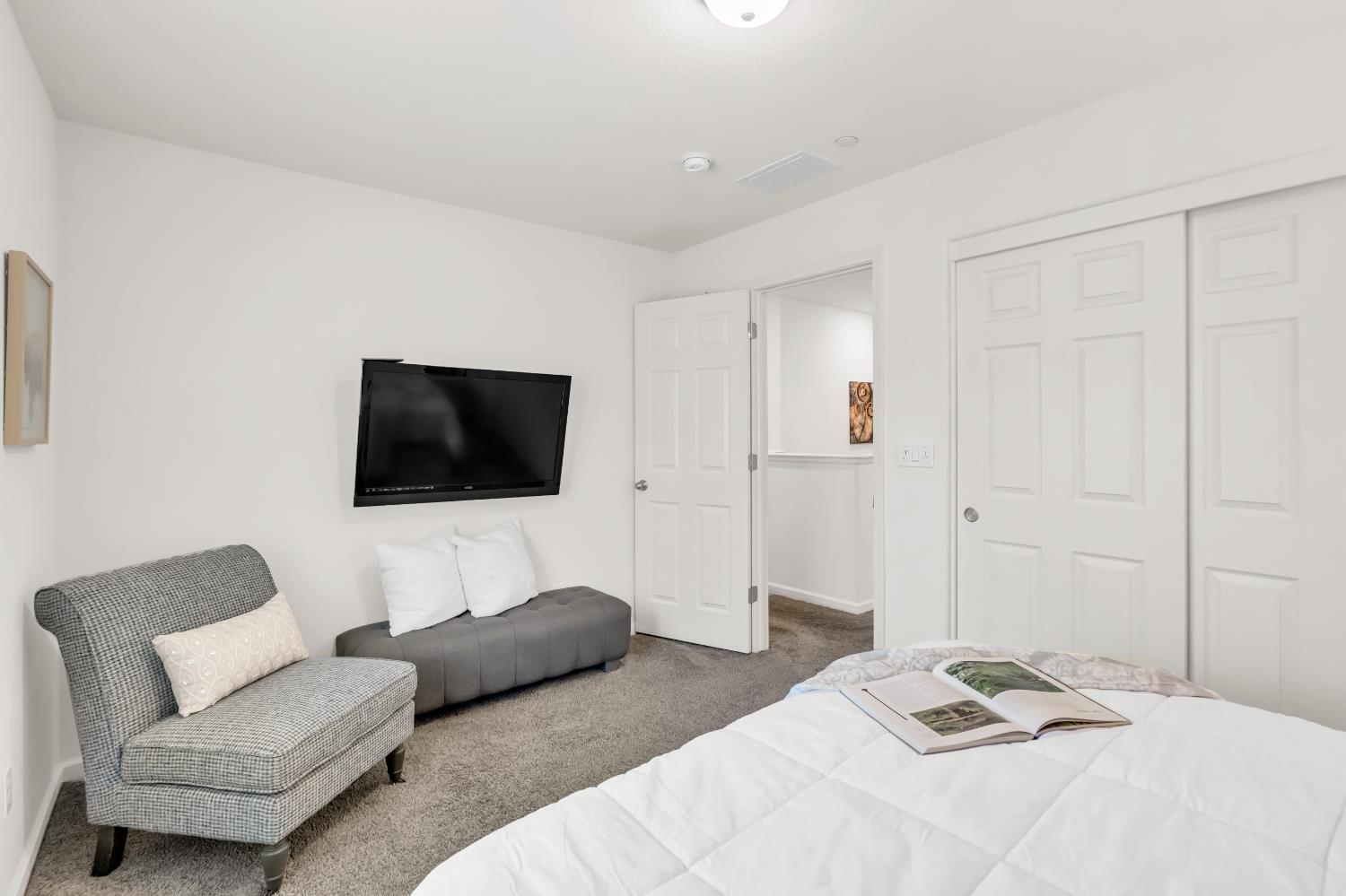 8193 Kramer Ranch Way Elk Grove, CA 95758 - Photo 26 of 48 a bedroom with a couch and a flat screen tv