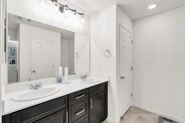 a bathroom with a sink double vanity and a mirror