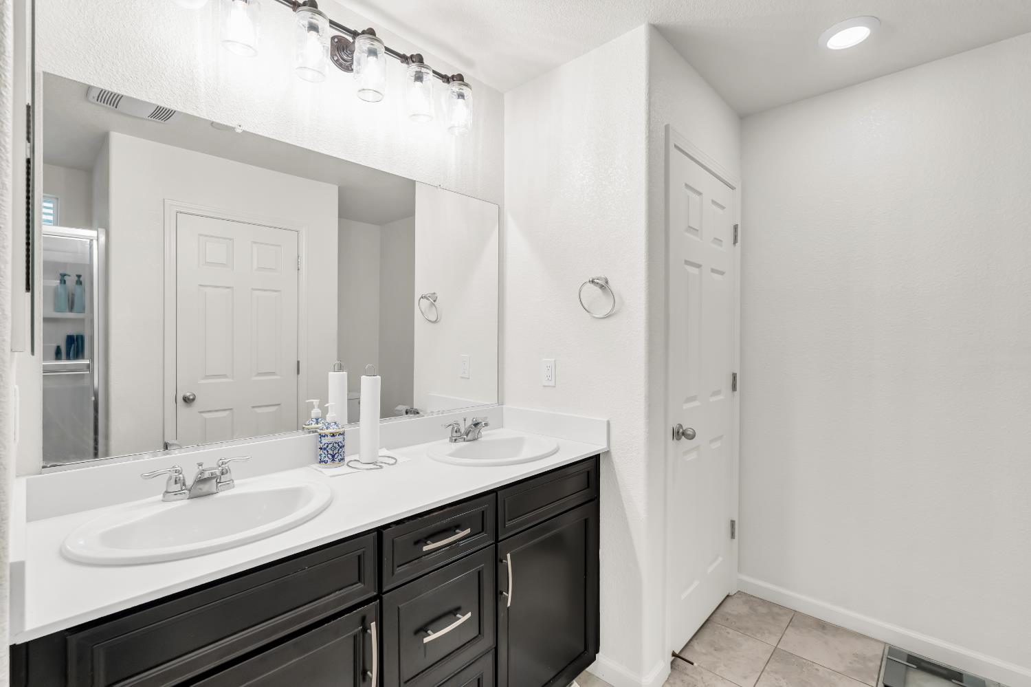 8193 Kramer Ranch Way Elk Grove, CA 95758 - Photo 30 of 48 a bathroom with a sink double vanity and a mirror