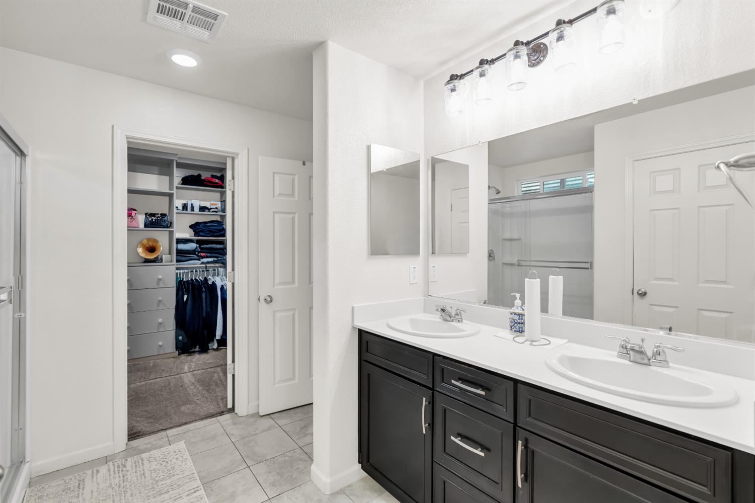 8193 Kramer Ranch Way Elk Grove, CA 95758 - Photo 31 of 48 a bathroom with a double vanity sink and a mirror