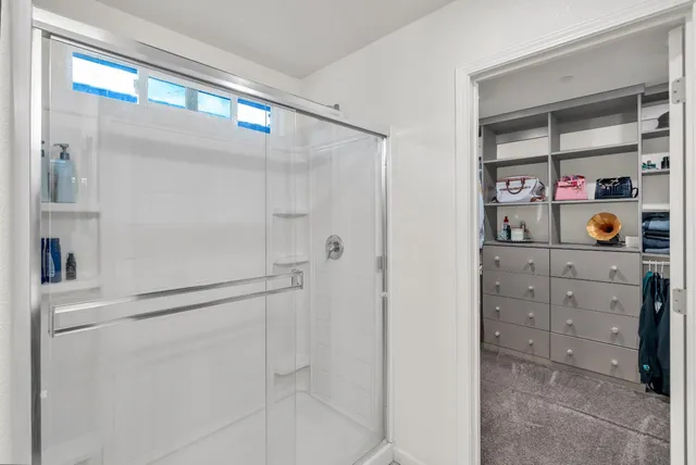 a bathroom with a shower and a mirror