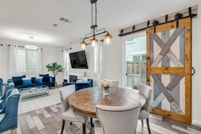 a living room with furniture a flat screen tv and a window