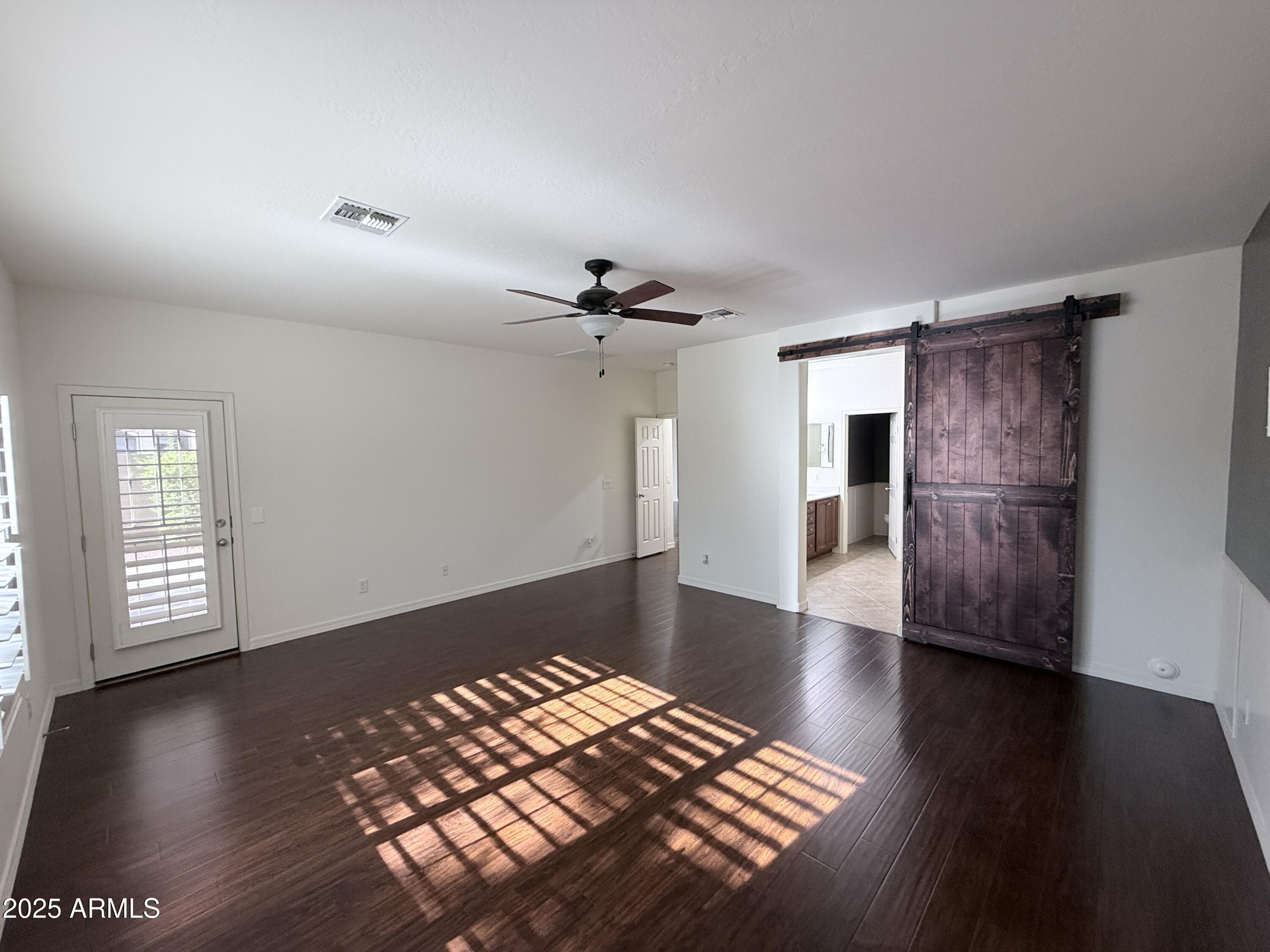 16549 West Rowel Road Surprise, AZ 85387 - Photo 14 of 23 a view of livingroom with hardwood floor and a ceiling fan