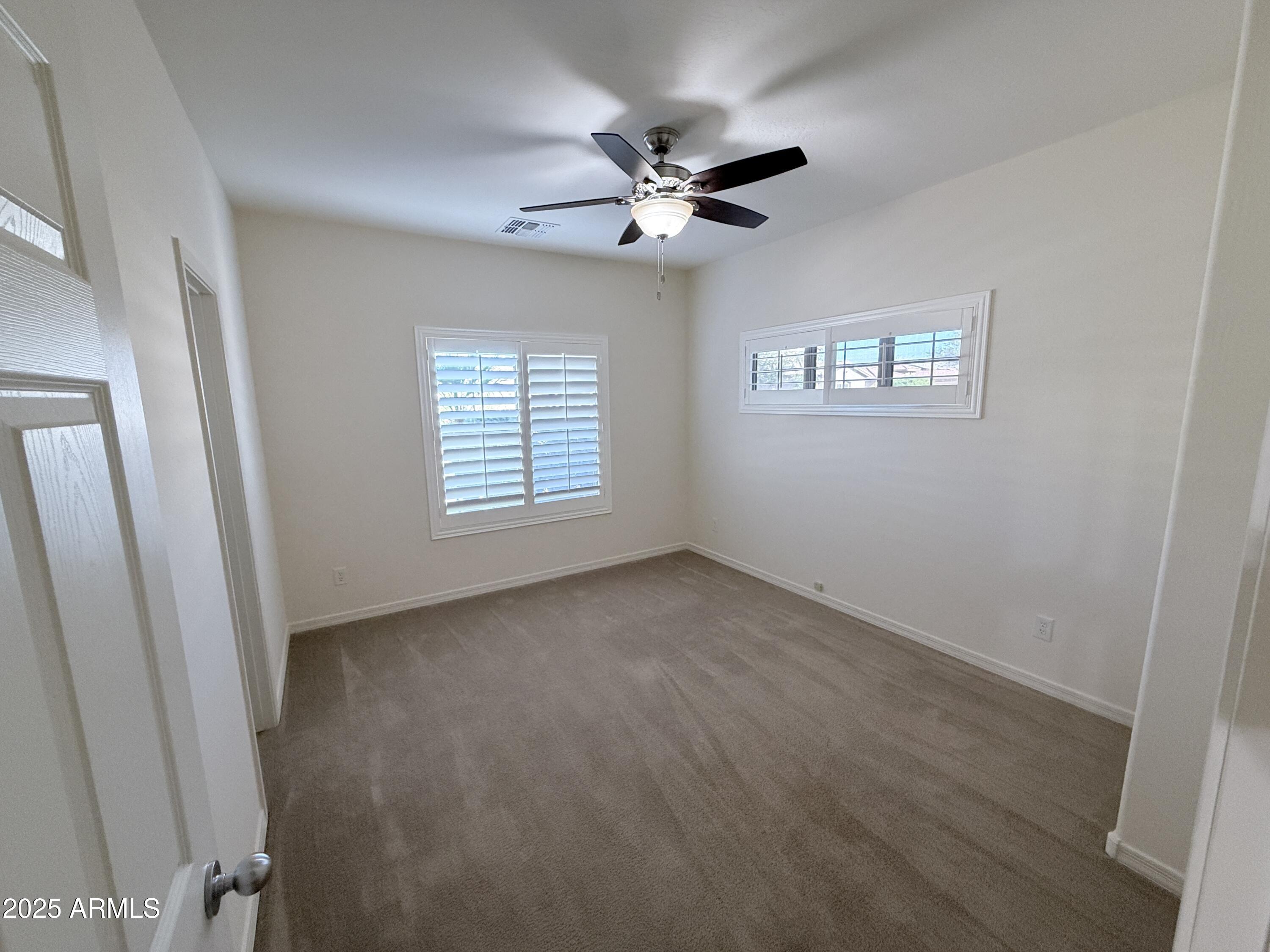 16549 West Rowel Road Surprise, AZ 85387 - Photo 6 of 23 a view of an empty room with a window