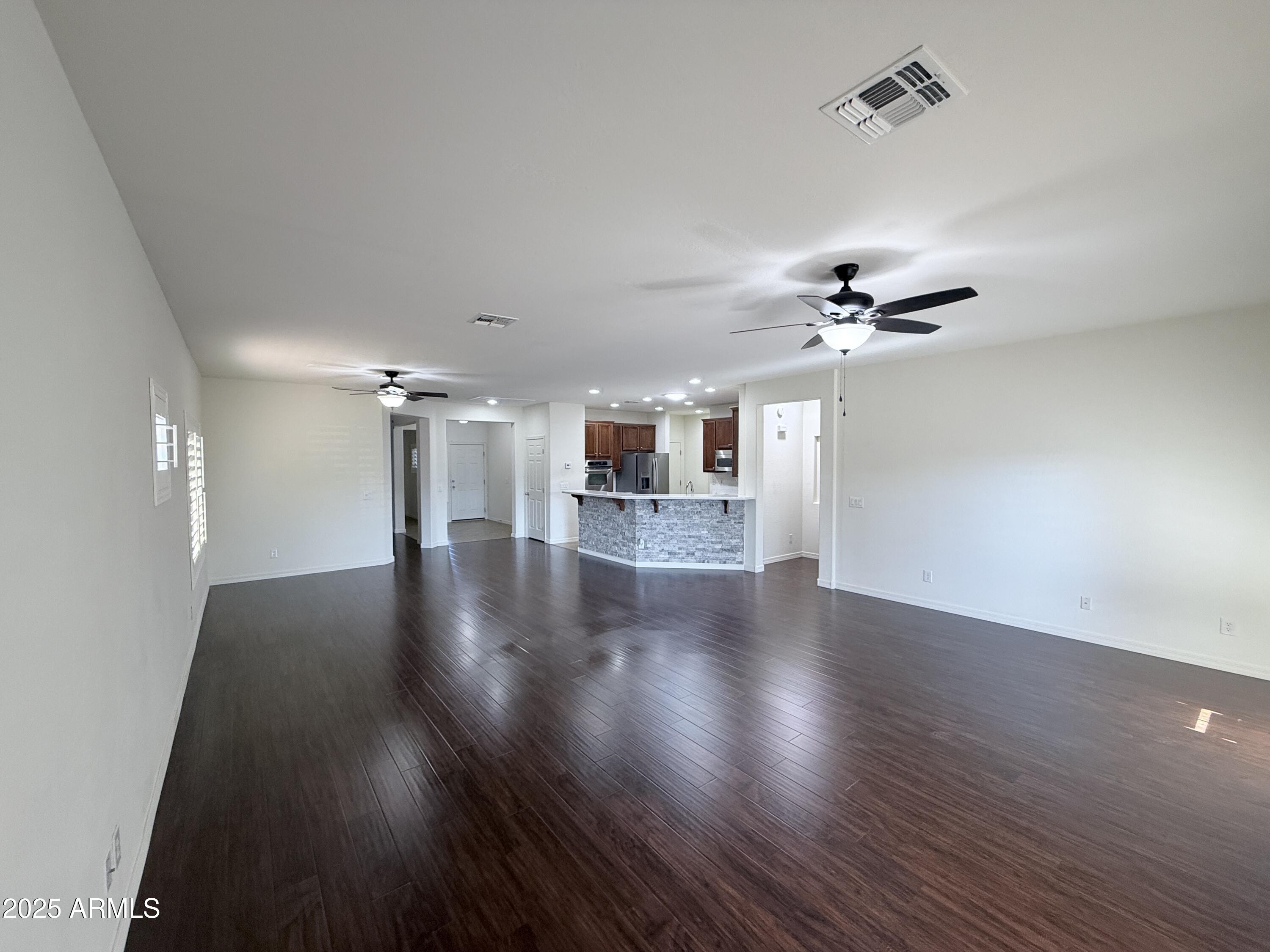 16549 West Rowel Road Surprise, AZ 85387 - Photo 10 of 23 a view of a livingroom with a hardwood floor