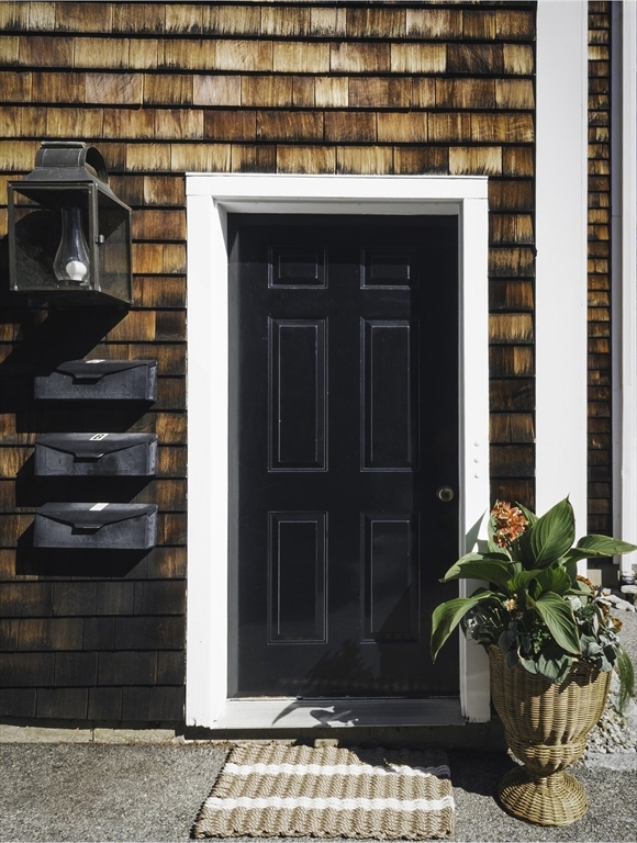 28 Elm Street, Unit 3 Manchester, MA 01944 - Photo 14 of 20 a potted plant sitting in front of a building