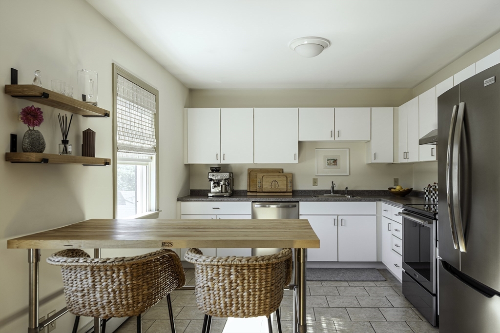 28 Elm Street, Unit 3 Manchester, MA 01944 - Photo 3 of 20 a kitchen with a stove a sink and a refrigerator
