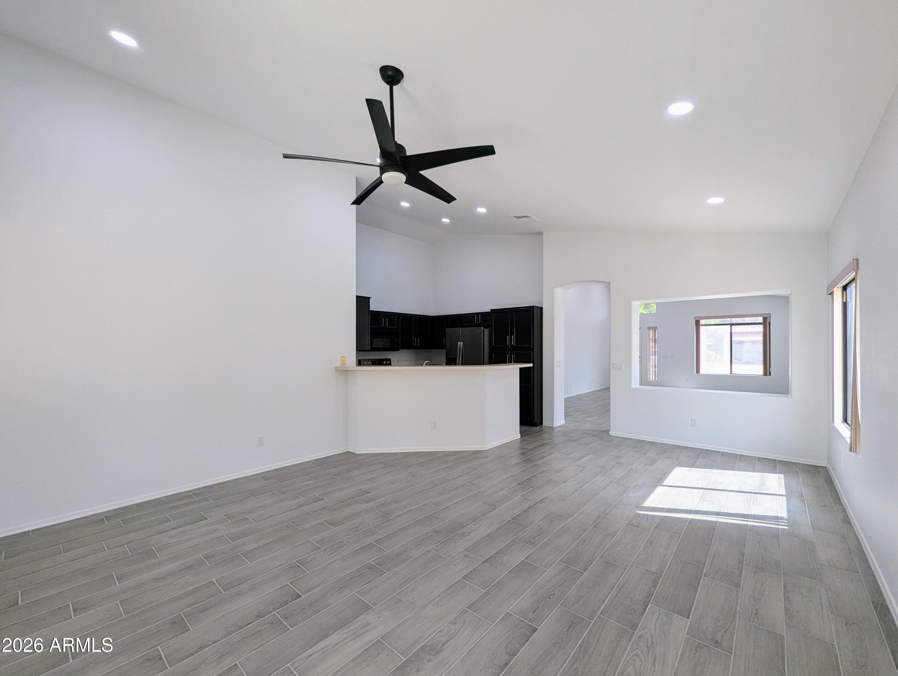 5424 West Wagoner Road Glendale, AZ 85308 - Photo 10 of 37 a view of an empty room with a window and wooden floor