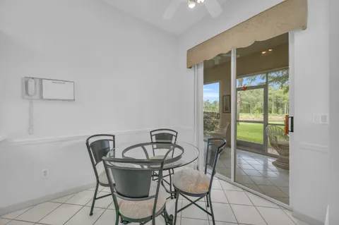 a view of a dining room with furniture and a potted plant