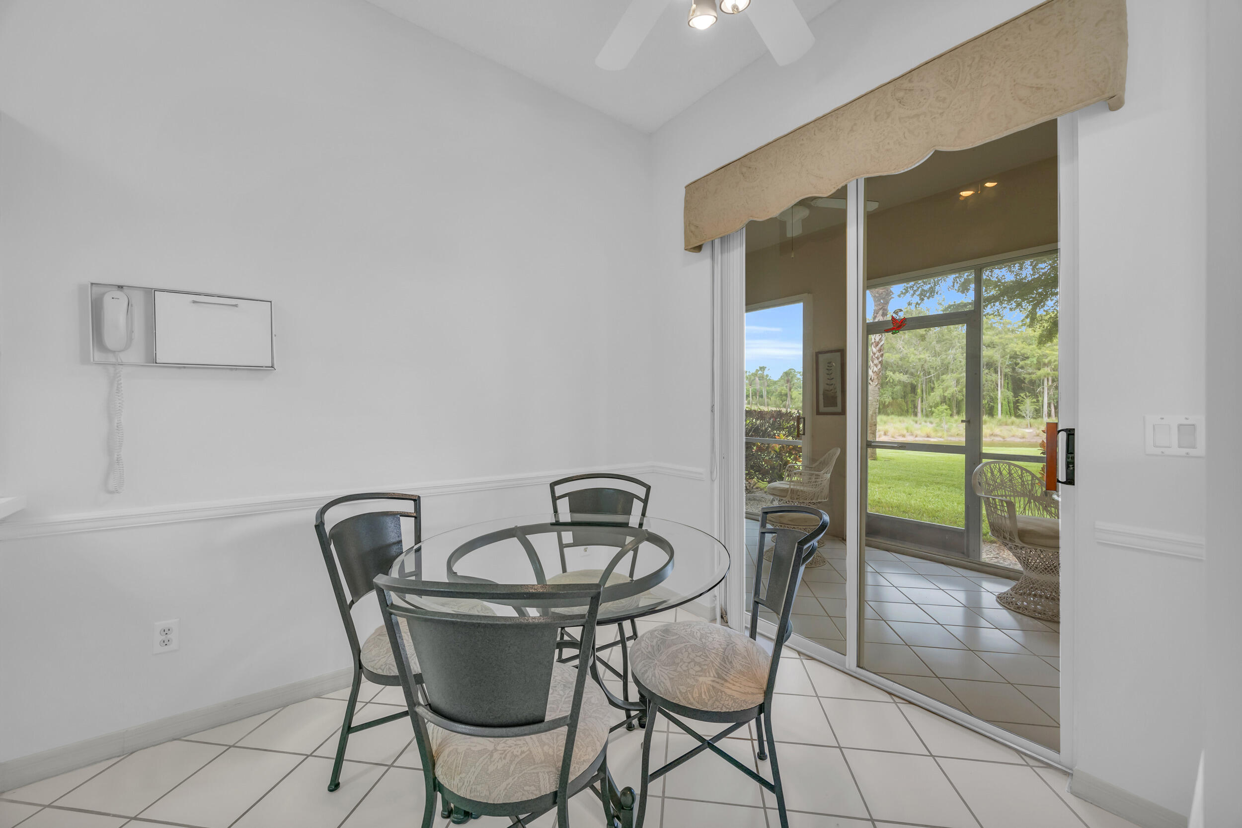 10172 Andover Coach Circle, Unit G2 Lake Worth, FL 33449 - Photo 15 of 64 a view of a dining room with furniture window and outside view