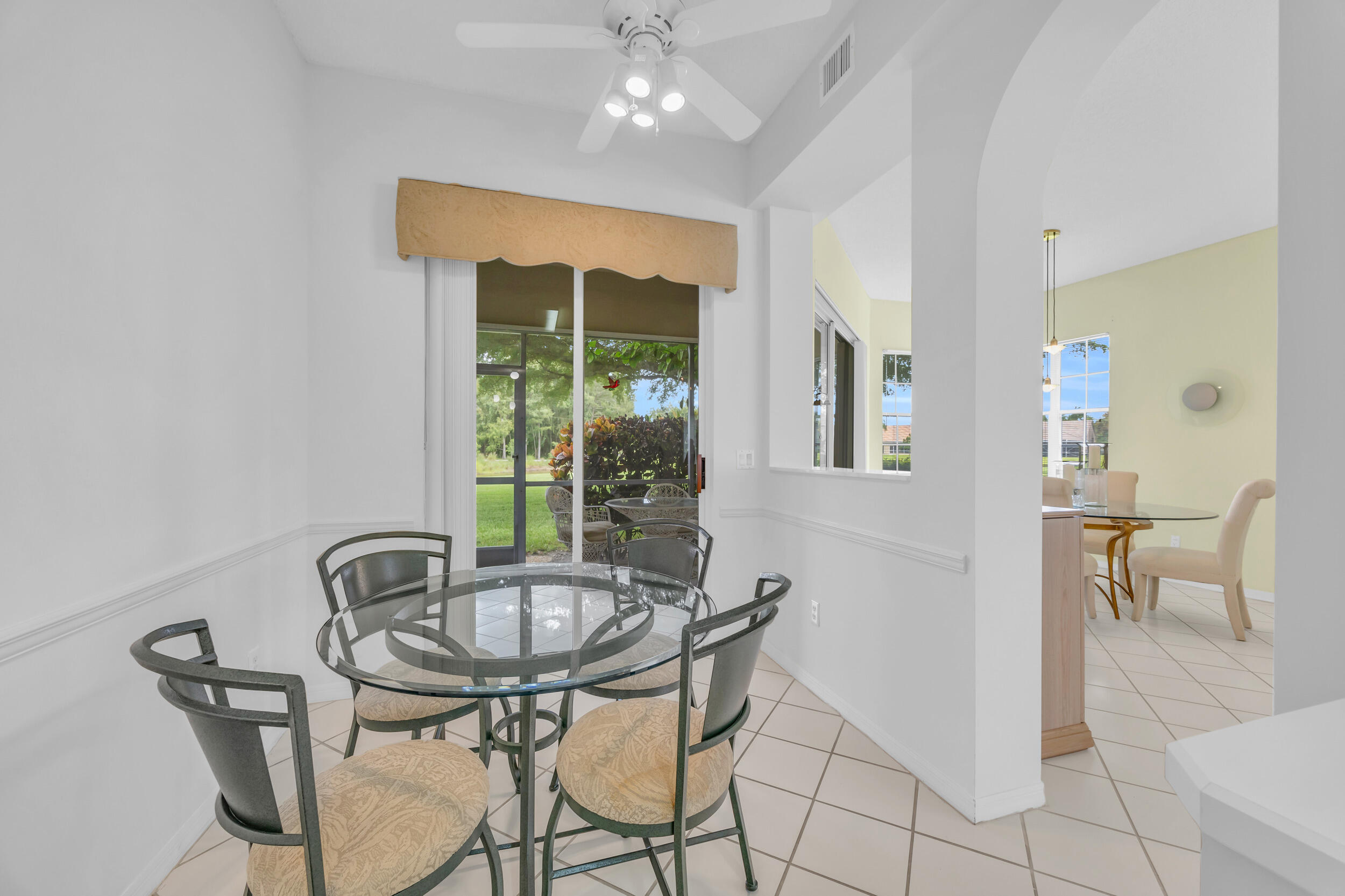 10172 Andover Coach Circle, Unit G2 Lake Worth, FL 33449 - Photo 16 of 64 a view of a dining room with furniture and a potted plant