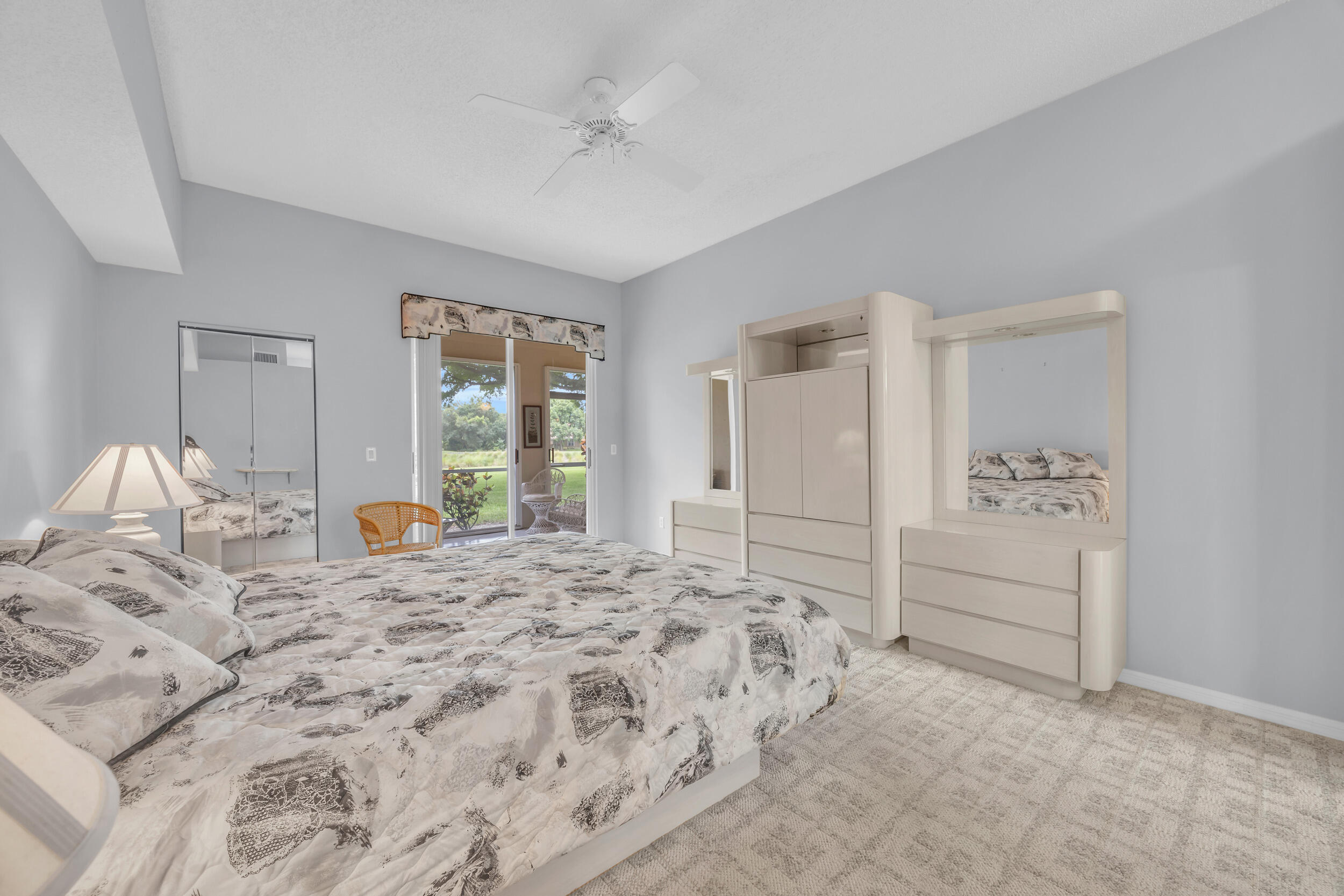 10172 Andover Coach Circle, Unit G2 Lake Worth, FL 33449 - Photo 21 of 64 a spacious bedroom with a bed and a window
