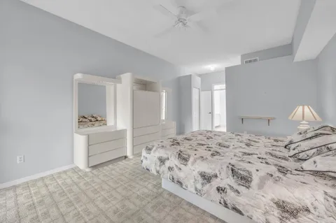 a bedroom with a bed and a dresser