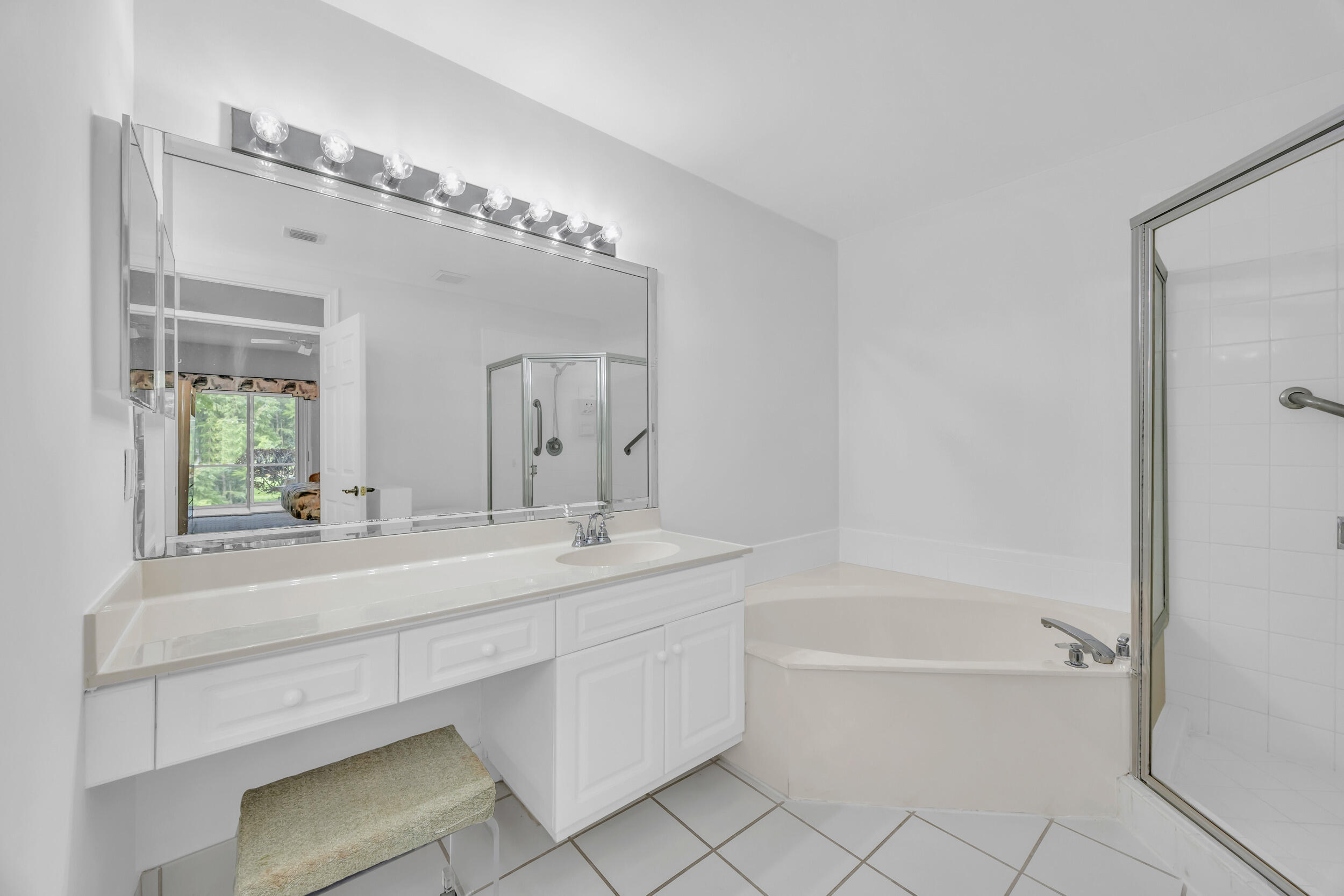 10172 Andover Coach Circle, Unit G2 Lake Worth, FL 33449 - Photo 24 of 64 a bathroom with a tub sink and mirror