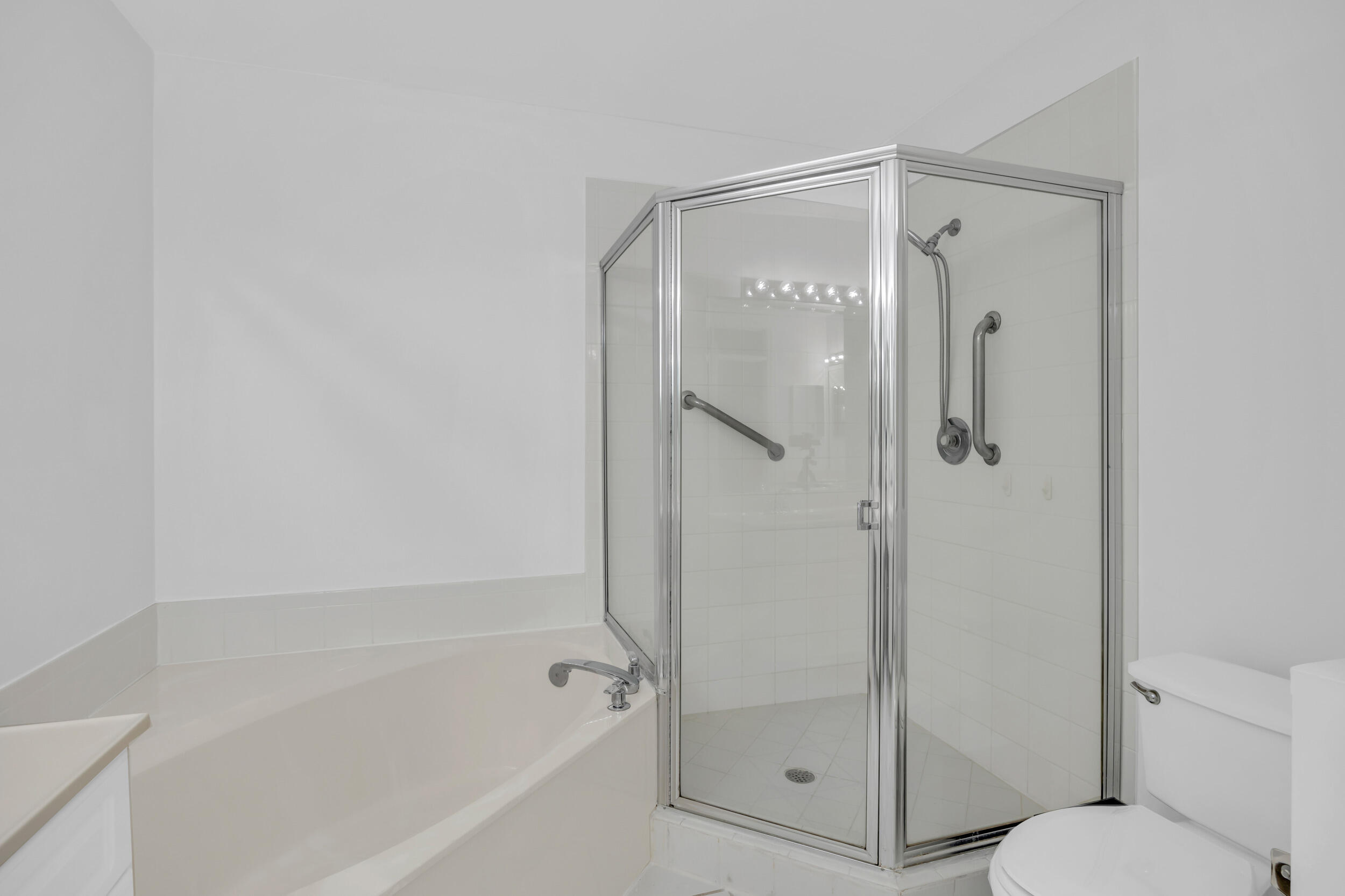 10172 Andover Coach Circle, Unit G2 Lake Worth, FL 33449 - Photo 26 of 64 a bathroom with a glass shower door