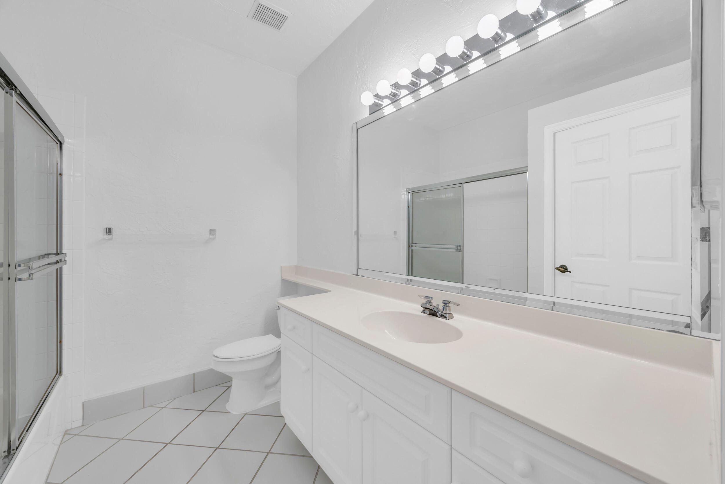 10172 Andover Coach Circle, Unit G2 Lake Worth, FL 33449 - Photo 30 of 64 a bathroom with a sink a toilet and shower