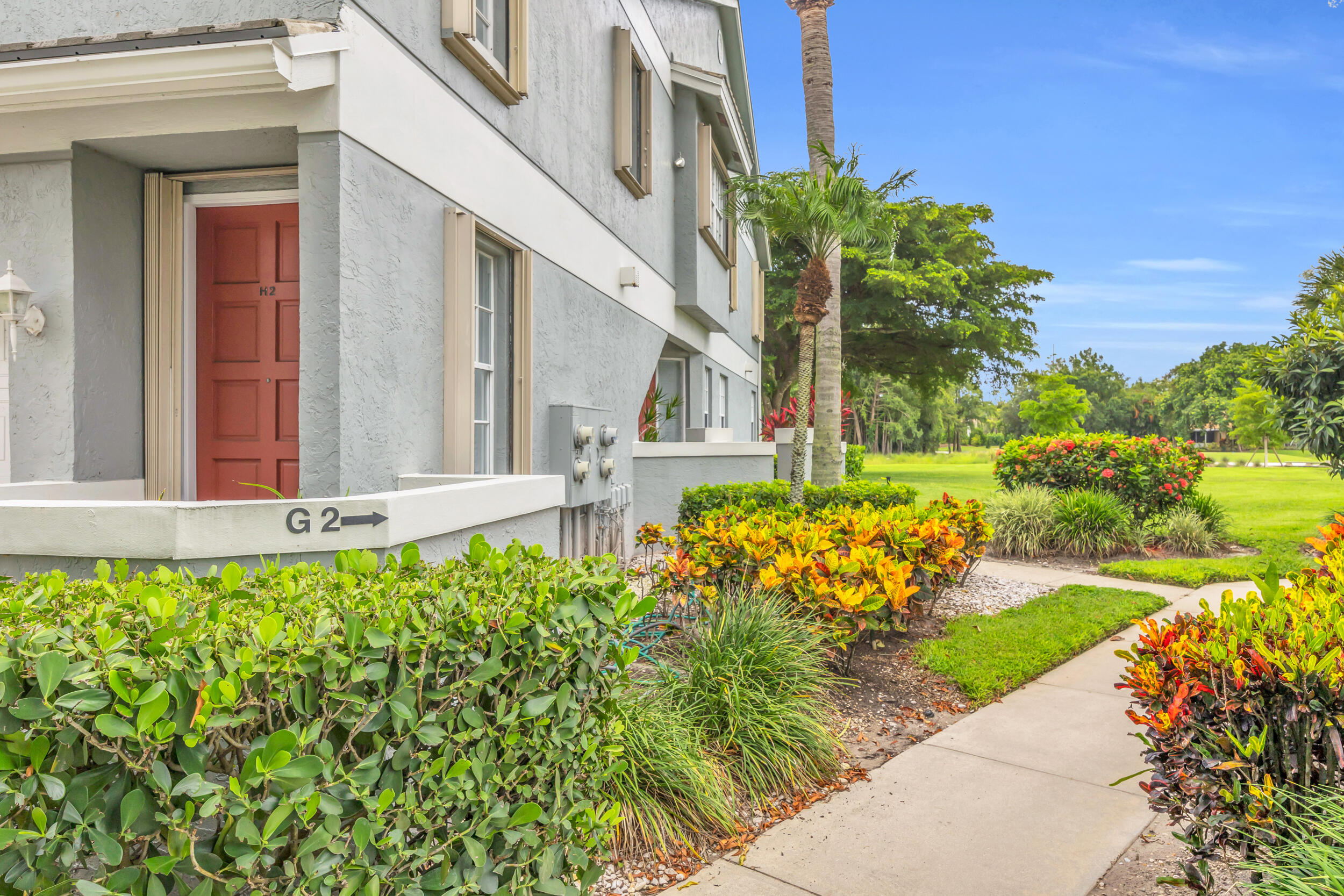 10172 Andover Coach Circle, Unit G2 Lake Worth, FL 33449 - Photo 3 of 64 a view of a house with a backyard and garden